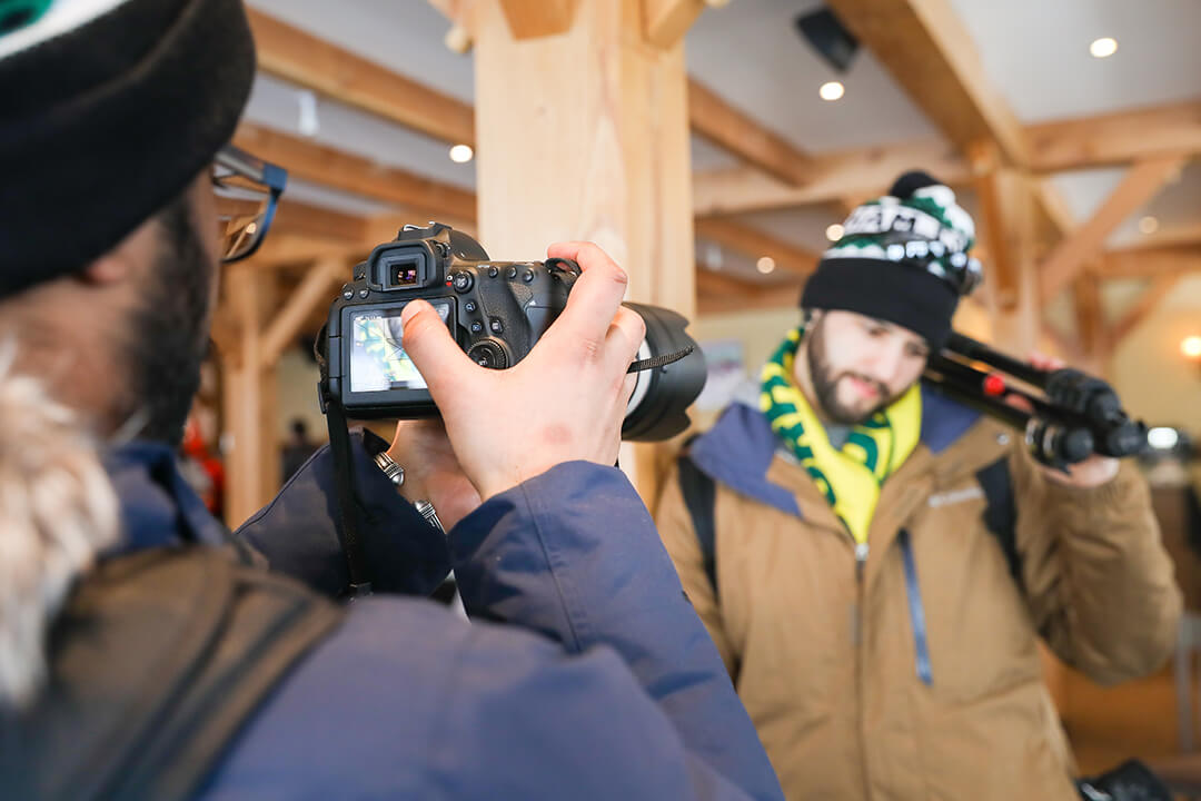 guy taking a photo of another guy in winter gear