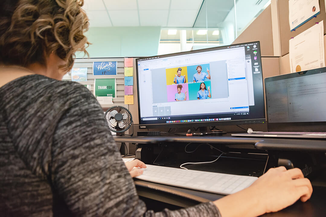 designer working on photo of nurses on her computer