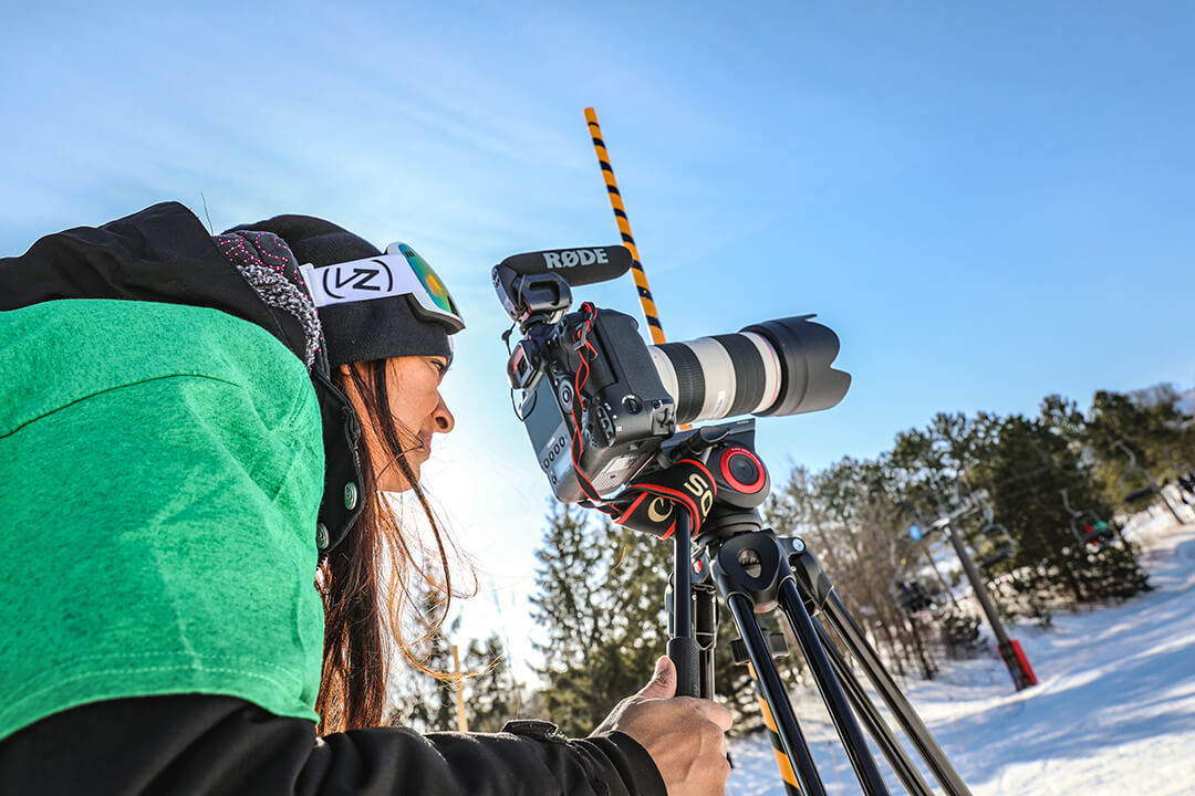 girl using a camera in the snow